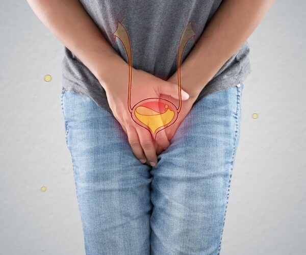 a man holding his hands over crotch holding in pee