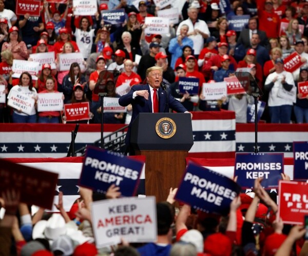 trump speaking at a large rally 