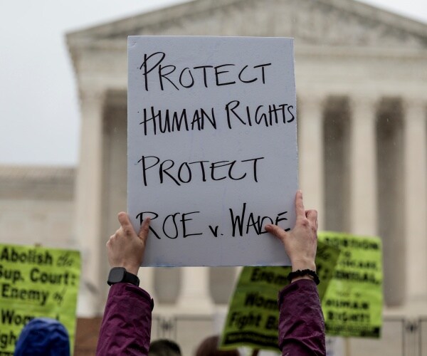an abortion-rights protester holds up a sign during a demonstration 