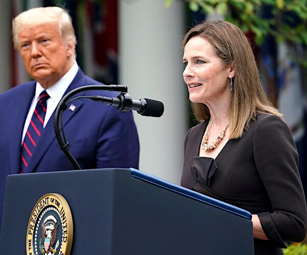 president donald trump looks on as judge amy coney barrett delivers her supreme court nomination acceptance