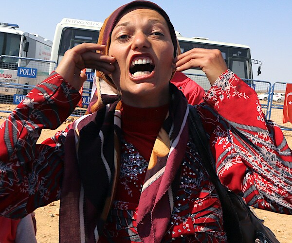 an angry woman exults in syria