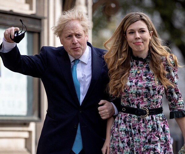 boris johnson and carrie symonds walk outside