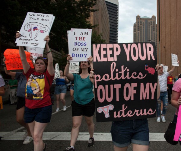 protesters carrying signs in the street
