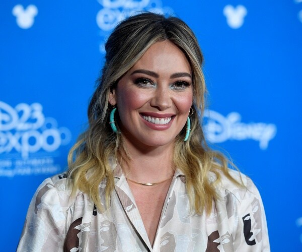 hilary duff stands on red carpet