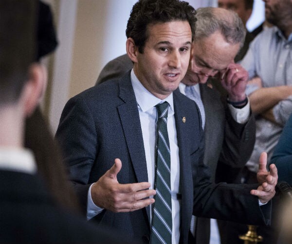 sen. brian schatz is shown speaking to the media