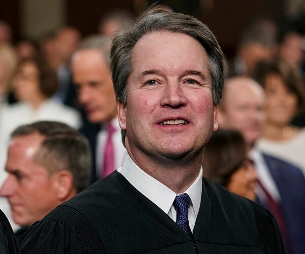 brett kavanugh stands in congress waiting for the state of the union address