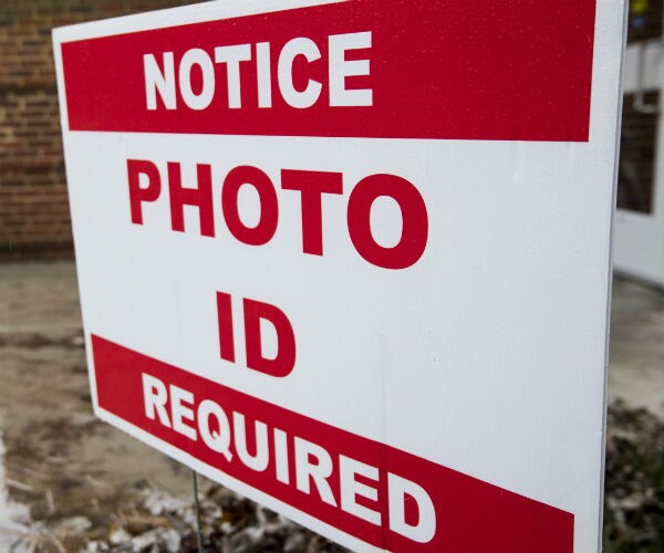 a sign reading photo i d required