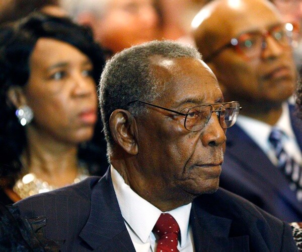 charles evers listens to a service in a pew