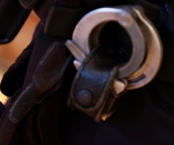 handcuffs seen attached to a police officer's trousers