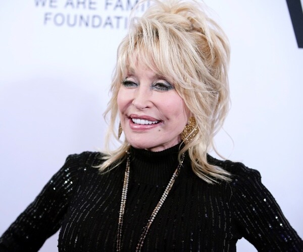 parton in a black sequined turtleneck outfit