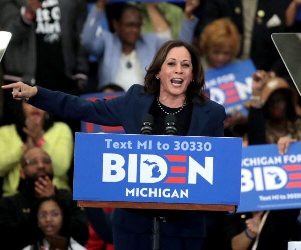 harris standing at a podium at a rally for biden