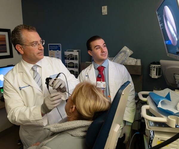 Duke researchers testing nasal swab on woman