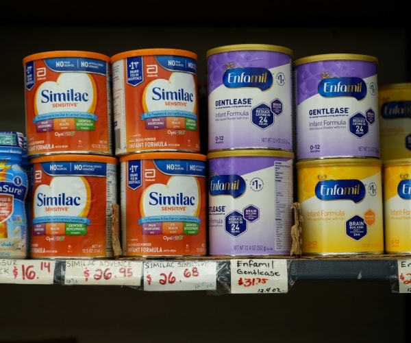 cans of different infant formula in store