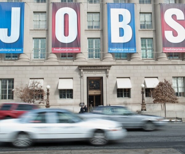 jobs banner hands on us chamber of commerce building as cars drive by