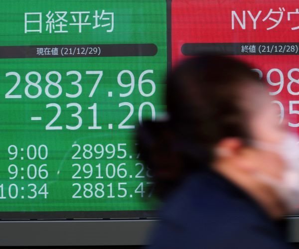 Nikkei and Dow indexes, as shown on a securities firm's board in Tokyo