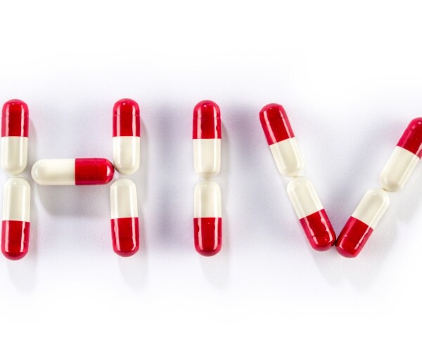 red and white capsules spelling out "HIV"
