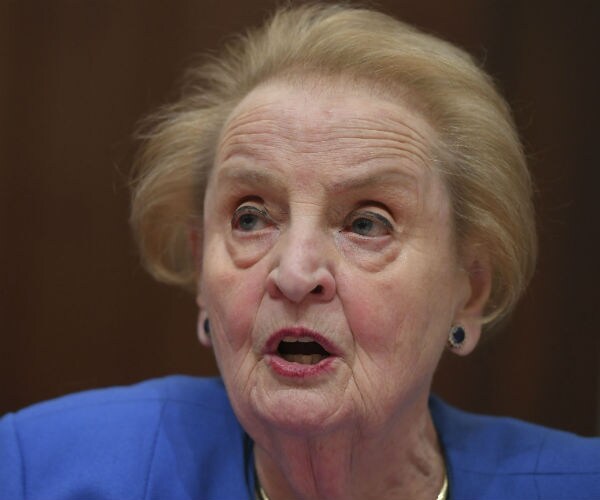 former secretary of state madeleine albright speaks during a hearing  on Capitol Hill in a powder blue dress