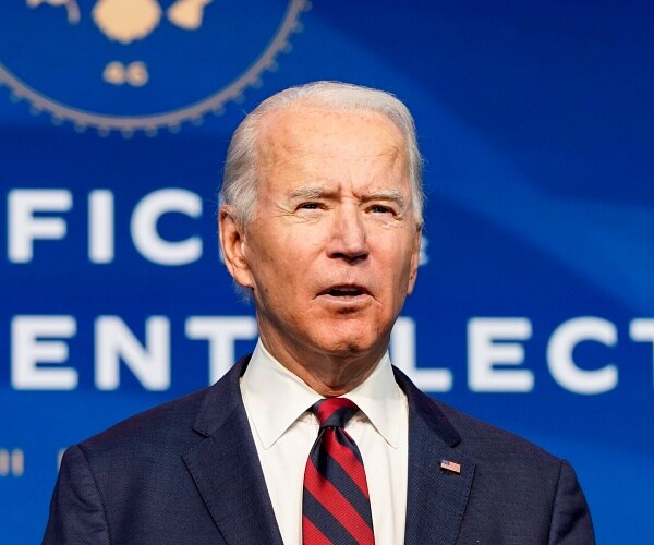 joe biden stand onstage behind podium