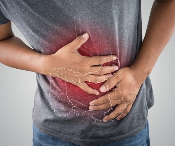 man holding his stomach in pain, with outline of intestines