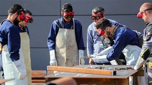 The Latest: Germany: Syrian Tries to Kill Wife, Dies in Fire