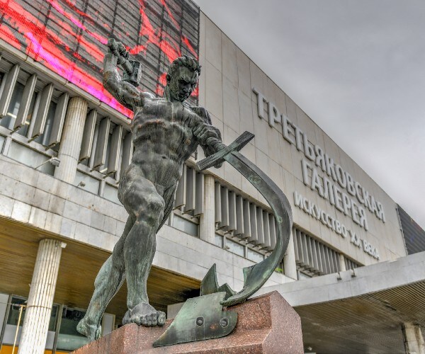 statue of a man beating a plow into a plow share