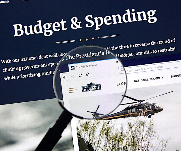 the white house budget and spending website shown through a magnifying glass