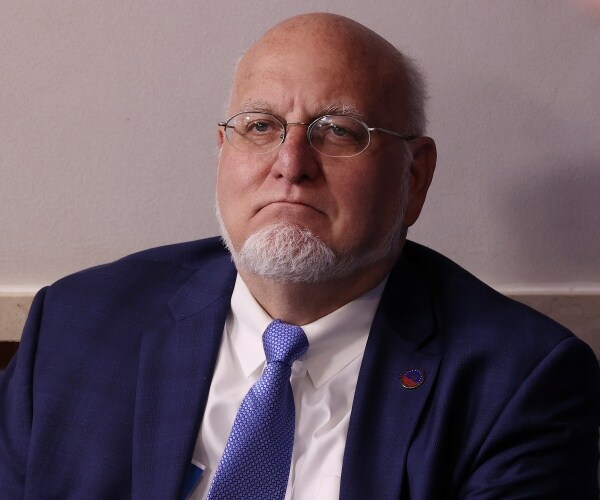 robert redfield wearing a blue tie white shirt and navy suit