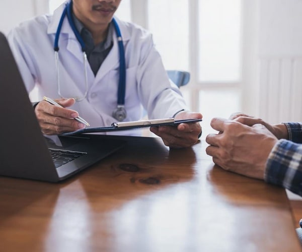 doctor talking to patient in his office