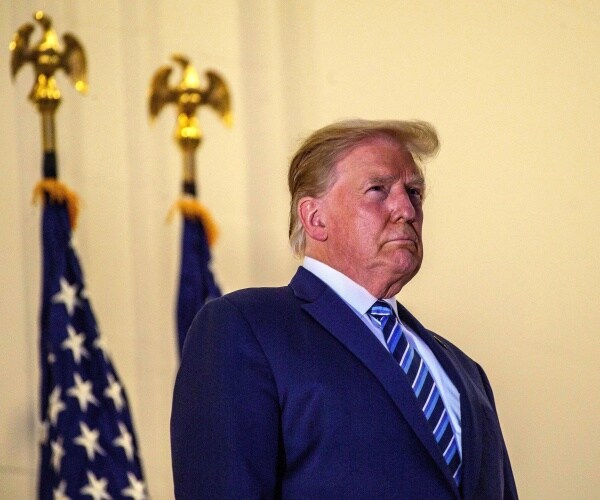 donald trump stands on truman balcony