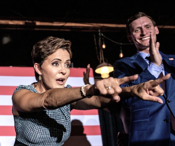 kari lake and blake masters waving to supporters