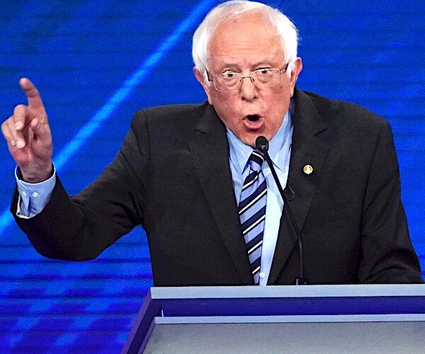 bernie sanders gestures and speaks during a democratic presidential primary debate
