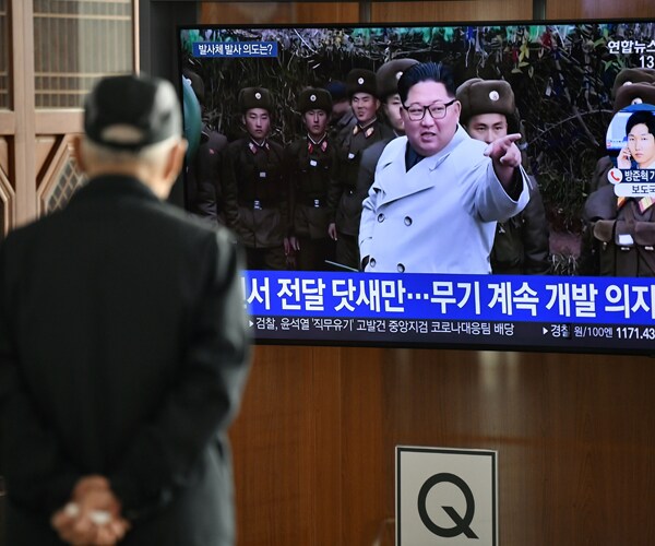 a man in south korea watches television footage of north korean leader kim jong un