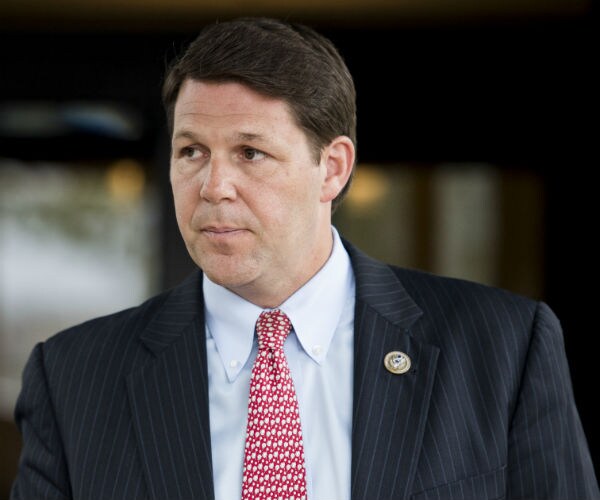 rep. jodey arrington is shown in a pin stripped suit, dress shirt and tie 