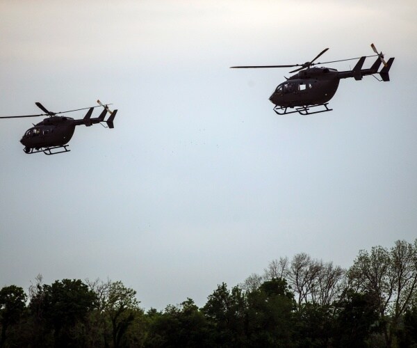 lakota helicopters fly above trees