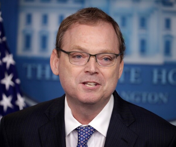 kevin hassett in a black suit and polka dotted blue tie in the press briefing room