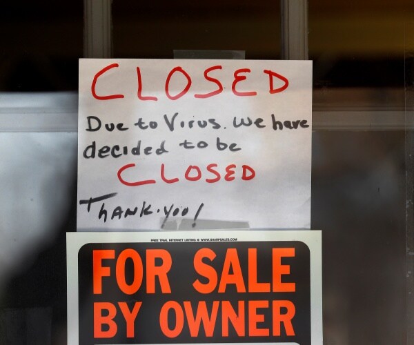 sign in window says a business is closed due to the coronavirus