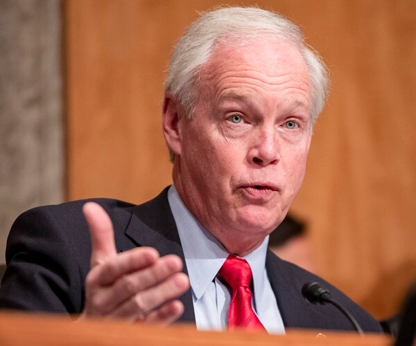 sen. ron johnson questions someone at a hearing