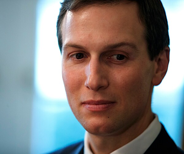 jared kushner looks down and to his left while photographed seated in the oval office
