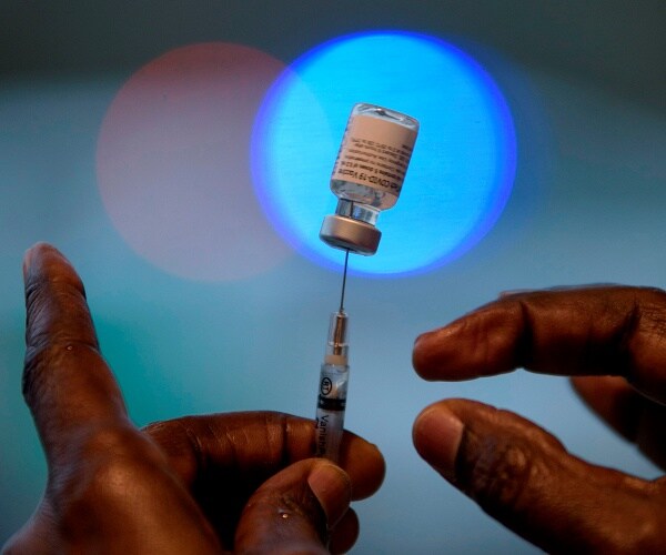 healthcare worker prepares vaccine