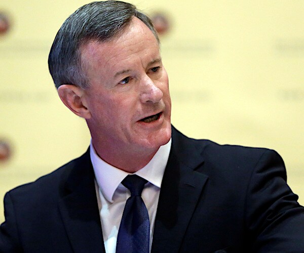 william mcraven looks to his left and speaks during a news conference