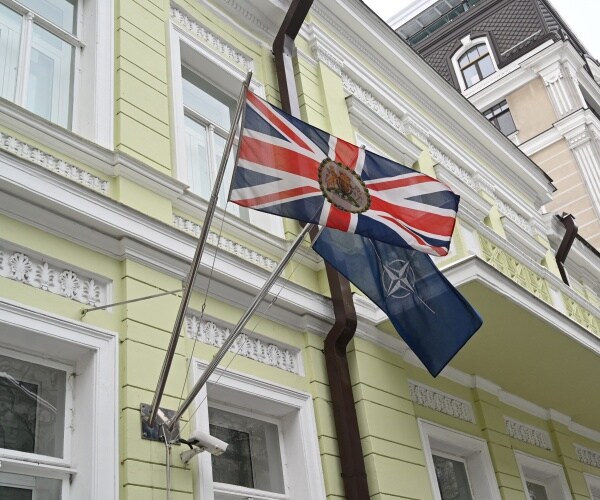 the flags of great britain and nato on a building