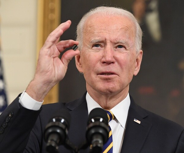 joe biden holds microchip up