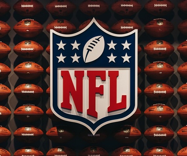nfl logo on wall of footballs