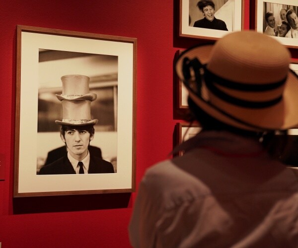 a person looks at a photograph on display