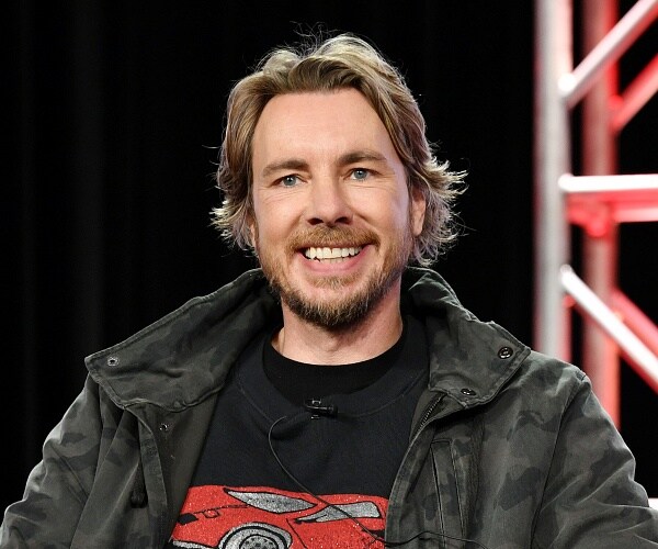 dax shepard sits onstage