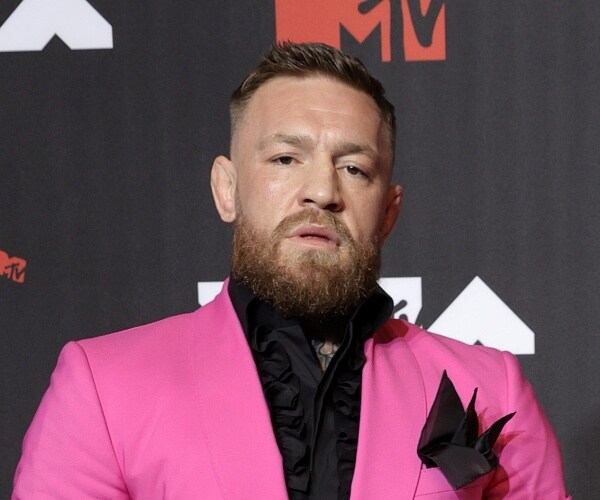 conor mcgregor stands on red carpet