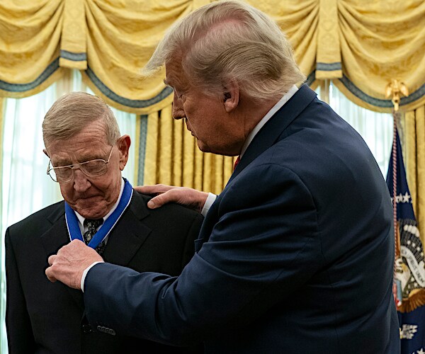 legendary football coach lou holtz is fitted with the presidential medal of freedom by president donald trump