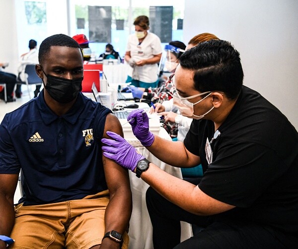 pharmacy student administers vaccine