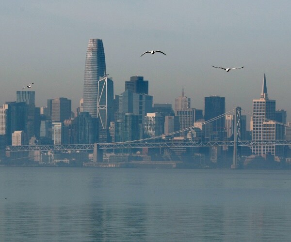 seabulls fly over the oakland bay bridge before the san francisco skylinle
