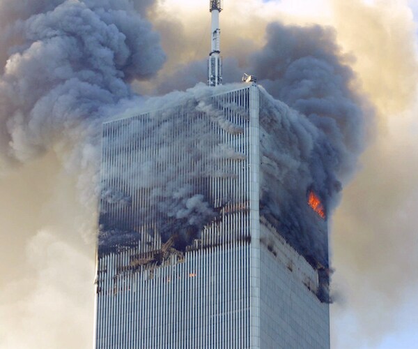 one of the twin towers is on fire after a plane crash on september eleventh